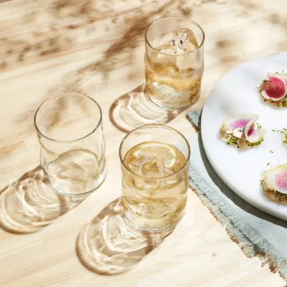 Vasos de vidrio Lava con bebidas claras en mesa de brunch o evento
